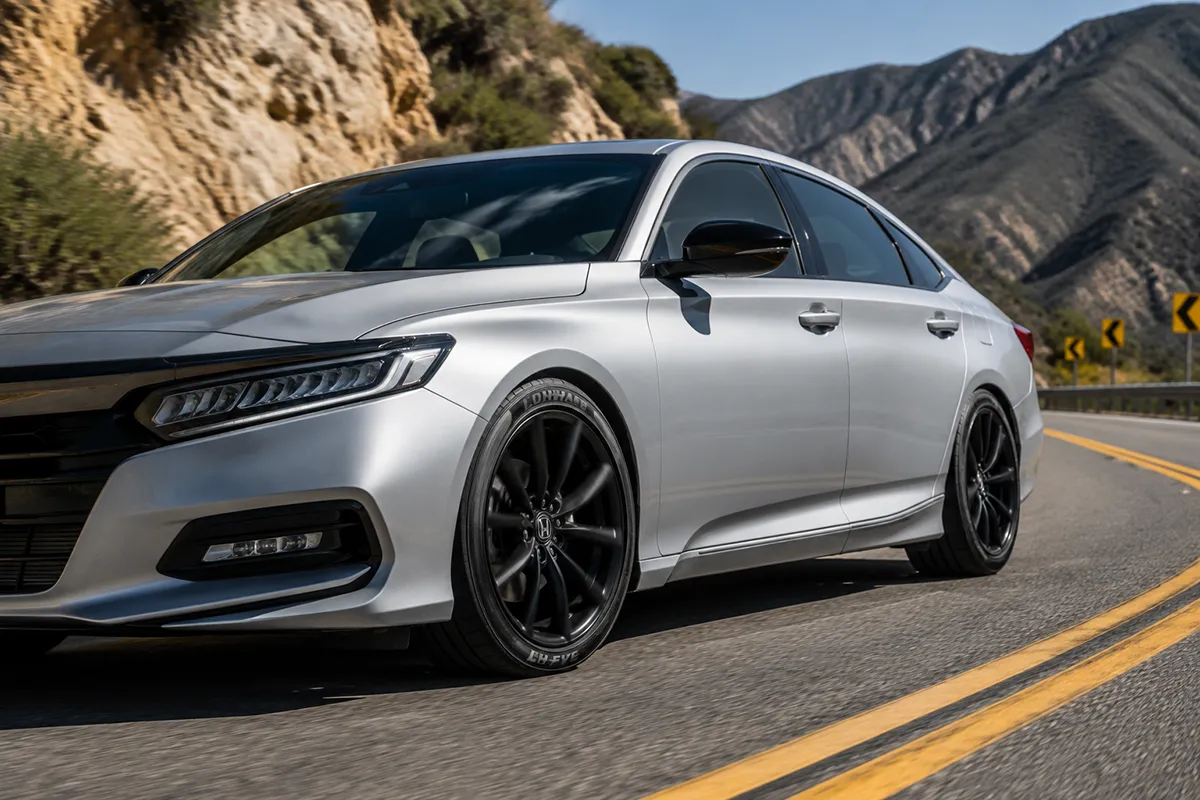 Performance sedan cornering on Lionhart LH-FIVE tires on a dry mountain road