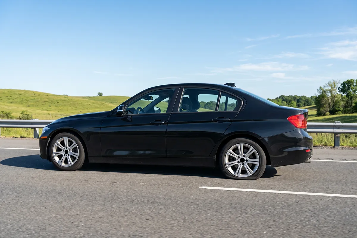 Driver safely driving on a run flat tire after a puncture on a highway