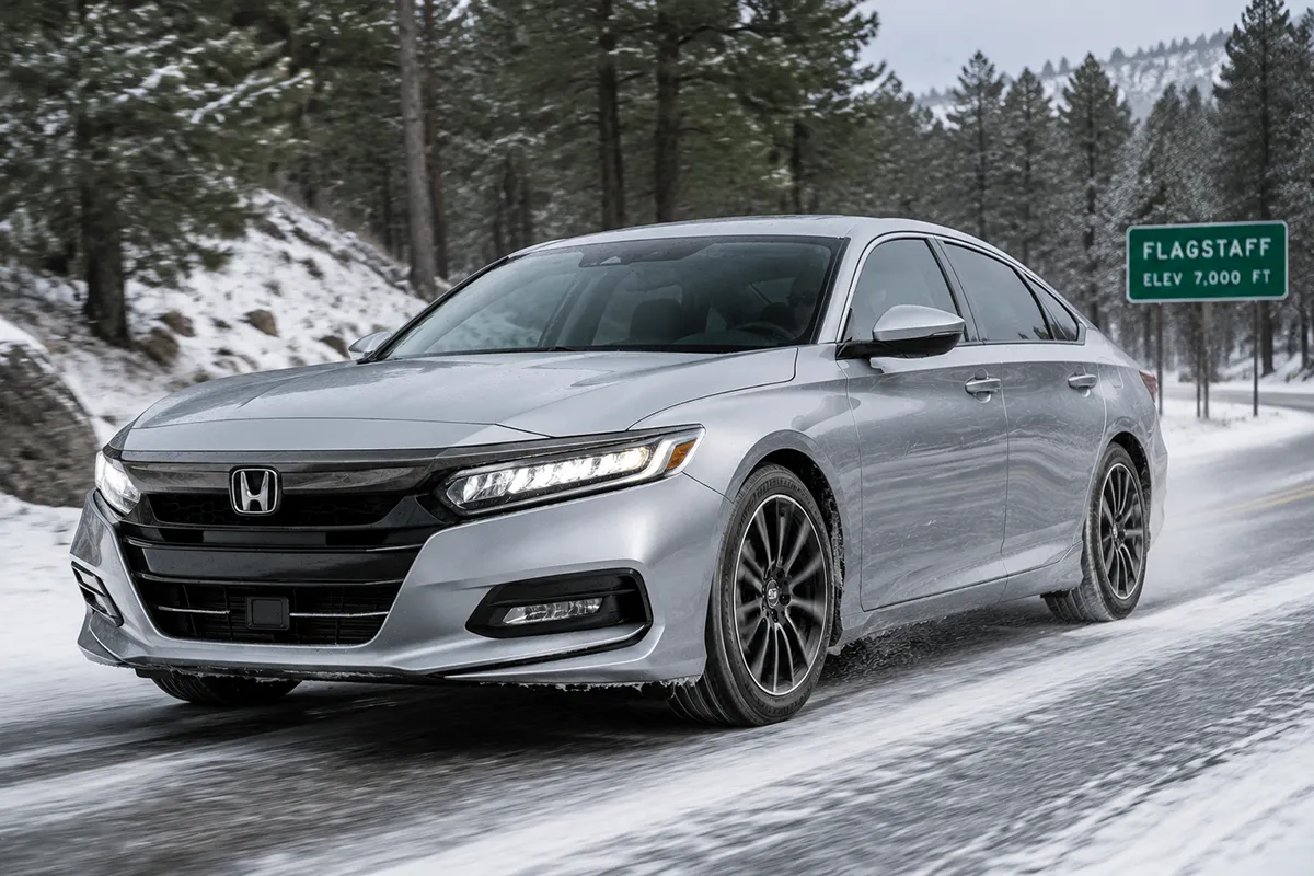 Honda Accord with Bridgestone Turanza Everdrive tires driving on a lightly snow-covered road near Flagstaff, Arizona
